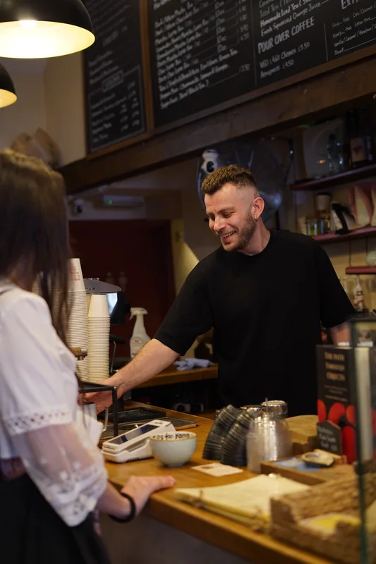 Barista serving a guest at the counter